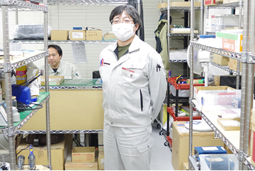 部品倉庫に立つ谷村雅史